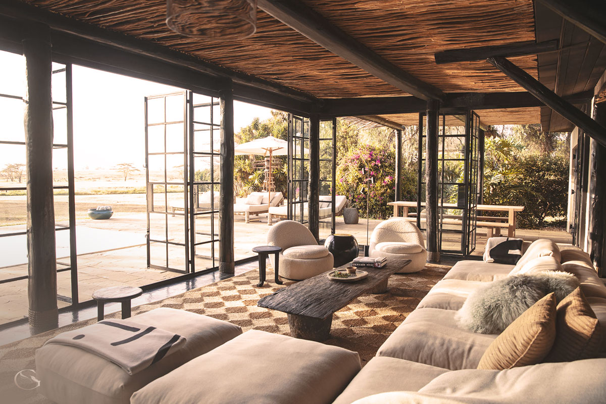 A large outdoor lounge and private pool that rolls onward toward views of Mount Kenya